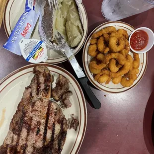 One pound Delmonico ribeye cooked perfectly medium, fried shrimp and a hot baked potato..
