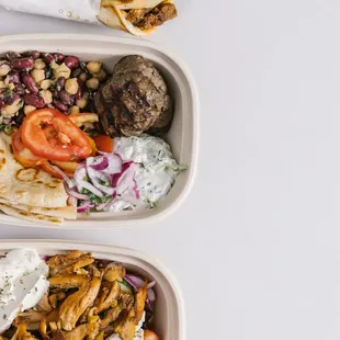 two trays of food on a white surface