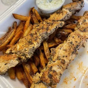 Chicken kebabs with spicy fries and side of tzatziki
