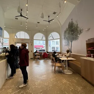 people in a cafe with tables and chairs