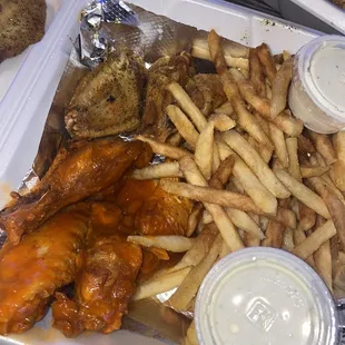 a tray of chicken wings and french fries