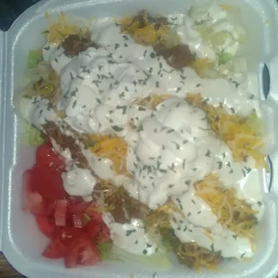 Taco salad made by the young lady with glasses. Ask for her.