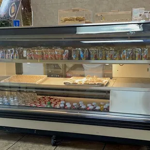 a display case with a variety of food items