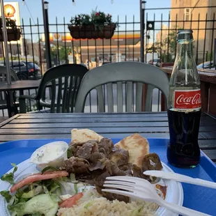 Outdoor dining with Gyros Plate ($15.49) and Mexican Coke ($2.95)