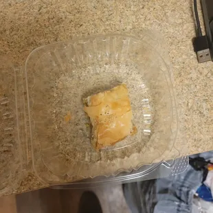 a square piece of food in a plastic container