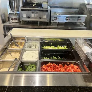 a salad bar with a variety of salads