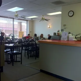 people sitting at tables in a restaurant