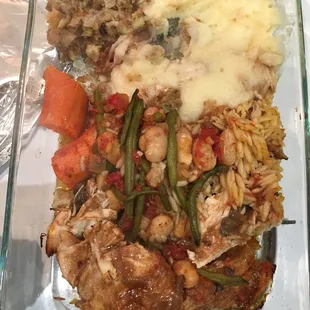 Turkey with traditional orzo and green beans and Lima beans along with a carrot and stuffing and mashed potato for thanksgiving