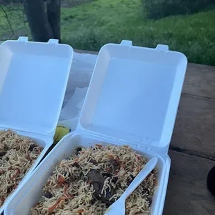 two take out containers of food