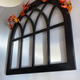 an arched window with fall leaves