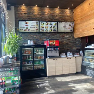 Entryway, Soda machine, menu and dessert and pita counter.