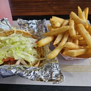 Pita sandwich with falafel and an order of fries.