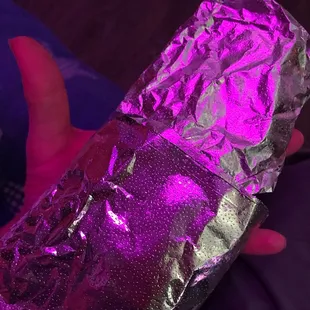 a hand holding a foil wrap