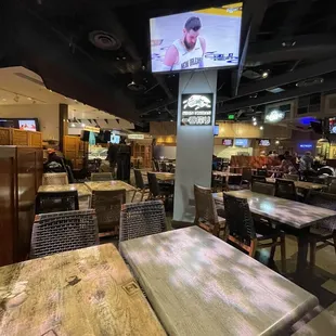 a restaurant with tables and televisions