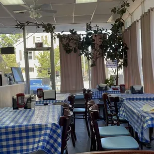 tables and chairs with blue and white checkered tablecloths