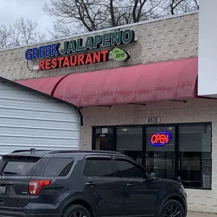 a car parked in front of a restaurant