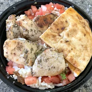 Greek Burrito Bowl - chicken, seasoned rice, tomato, onion, parsley, feta, pita bread and tzatziki