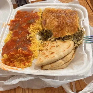 Carryout order of spinach pie with rice pilaf and pita bread. Cole slaw on the side (not shown)