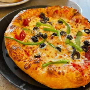 a pizza with olives and peppers
