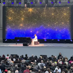 a woman in a white dress on stage