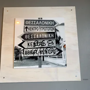 street signs on a wooden frame