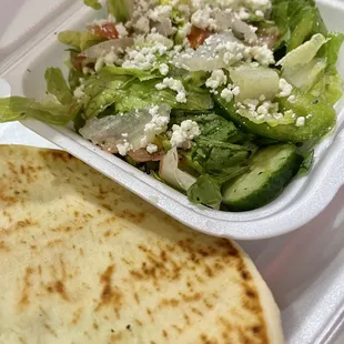 a salad in a styrofoam container