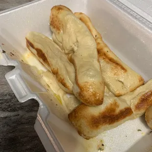 a piece of bread in a styrofoam container