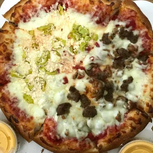 Medium pizza with half and half toppings and sides of cheese sauce to dip the crust in.