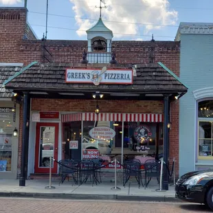 A photo to show the eating area is in front of Greeks Pizzeria.