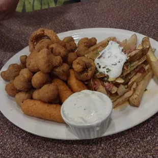 The sampler platter  Mushrooms, cheese sticks, cheese curds, onion rings , loaded fries, jalapeno poppers