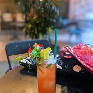 a glass of iced tea with a straw and garnish