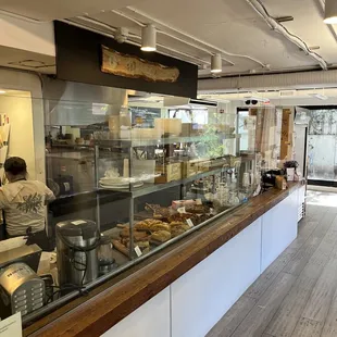 a bakery counter with a variety of baked goods