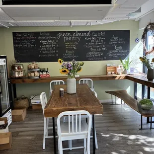 a wooden table and white chairs