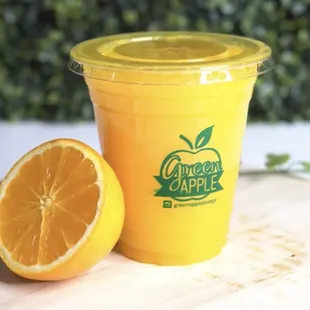 a cup of juice and a half of an orange