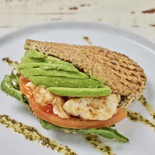 a grilled sandwich with avocado