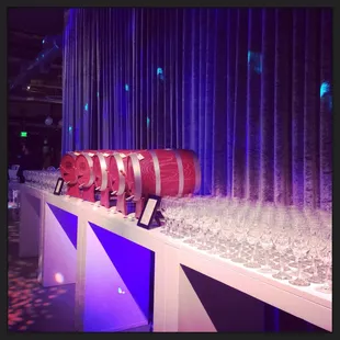 a row of wine glasses on a bar
