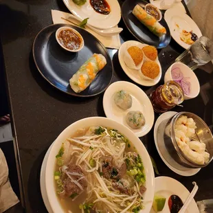 Pho, side of summer rolls, and dim sum (chive dumplings, roasted pork buns, sesame rolls)