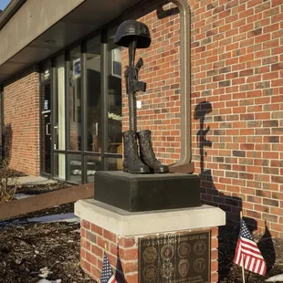 a statue of a fire hydrant and american flags