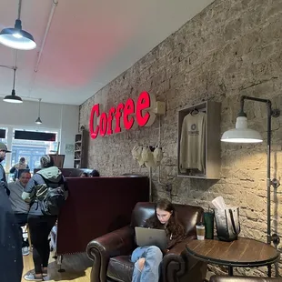 a woman sitting on a couch in a coffee shop