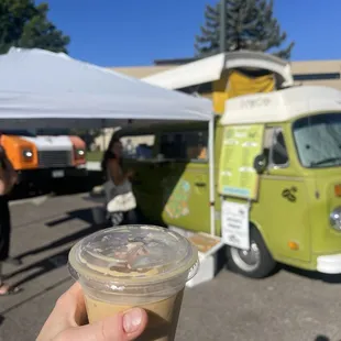 a hand holding a cup of coffee