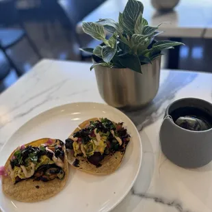 a plate of food and a cup of coffee