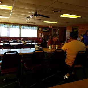 people sitting at tables in a restaurant
