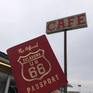 a hand holding a passport