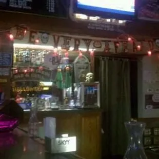 a bar with a neon sign above the bar