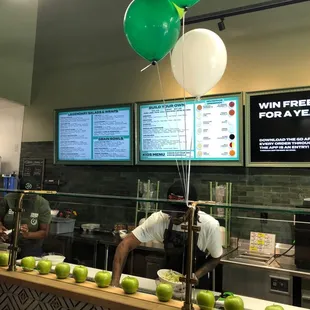 a restaurant counter with a menu and balloons