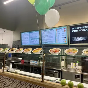 a restaurant counter with food and balloons
