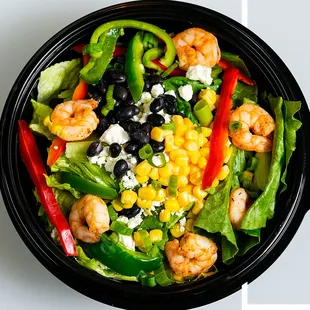 TEQUILA MOCKINGBIRD Shrimp, feta cheese, corn, black beans, red and green peppers, and green onions. Topped with tortilla strips.