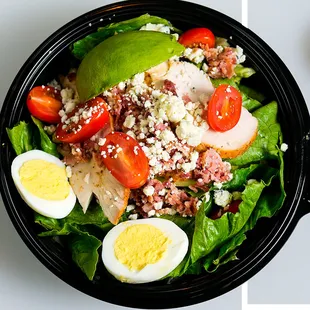 WHAT ABOUT COBB Chicken, bacon, crumbled blue cheese, hard-boiled egg, grape tomatoes, and diced avocado.