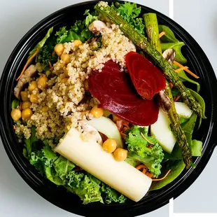 YOU ARE WHAT YOU BEET Quinoa, beets, shredded carrots, grilled asparagus, chickpeas, hearts of palm, and white mushrooms. Topped with sunflo