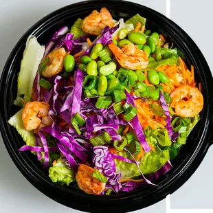THAI ONE ON Chicken or shrimp, red cabbage, carrots, edamame, cucumber, and green onions.  Topped with peanuts and chow mein noodles.